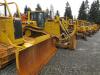 The dozers are lined up, waiting for their new own