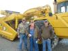 (L-R): Larry Harvel, Danny Schnepper and Keith Harvel in front of a John Deere 862B scraper. 
