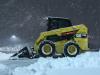 The News Journal photo
A Cat skid steer removes snow from the parking lot as snow falls Friday at Newark Shopping Center in Newark, Del.