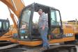Troy Dahle, owner of D&T Equipment, Morristown, Minn., checks out this Case CX210B excavator. 