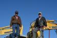Mexican farmers Nick Klaus (L) and Frank Wall stand atop a Komatsu 228 excavator, which they would later bid on.
