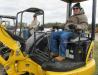 Larry Clapp (R) of Clapp Excavating in Ashmore, Ill., tries on a Komatsu PC55 mini-excavator while Rick Bowman of Expert Excavating Inc., based in Fort Pierce, Fla., tries out a Bobcat 435 mini-excavator.