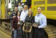(L-R): Ken Scott, 1st Class mechanic, Ransome CAT; Denise Feger and her son, Carson Feger; and Mike Lineman, technical services supervisor, Kristin Bromley-Fitzgerald, Ransome CAT president, and Mike Rigby, shop floor manager (main shop), all of Ransome C