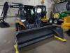 This popular John Deere 320E skid steer comes with an MTS 8 ft. (2.4 m) pusher plow snow removal package. 