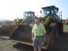 Steve Debaun, president, Track II Corporation, Lakeville, Minn., looks over these two Caterpillar 950K wheel loaders.