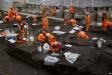 Archaeologists excavate the 16th and 17th century Bedlam burial ground uncovered by work on the new Crossrail train line next to Liverpool Street station in London, March 6, 2015.