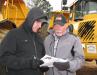Kevin (L) and Roger McHugh (r) of Brookside Equipment Sales, Phillipston, Mass., look over their notes.
