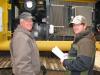 Steve Gross (L) and Justin Smedley of Gross Farms, Gadsden, Ala., get a better look inside this John Deere 290G excavator.