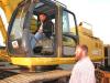 Luke (L) and Josh Smith, independent contractors, Atlanta, Ga., test out this John Deere 450C LC excavator.