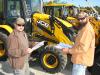 Timothy Moore (L), Moore’s Road & Land Maintenance, Ridgeland, S.C., and Brock Burnett, Burnette Construction Services, Ridgeland, S.C., compare notes about some of the new JCB backhoe loaders about to go on the auction block.