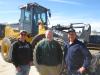 (L-R): Ryan Westaby, owner of Westaby Trucking, Shawn Vetterkind, Nortrax and Steve Sime, S&S Trucking, stand in front of the John Deere 644K wheel loader.