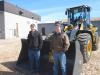 Ryan Burkholder (L) and Elvin Zimmerman, both of Burkholder Tractor, inspect this John Deere certified used 544K wheel loader. 