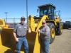 Travis Boyd (L) and Boone Peterson, both of Pierce County, Wis., highway department, check out the Cat wheel loaders. 