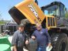 Ken Joniak (L) and Bill Schneider, both of Windy City Truck Repair, look at the engine of this Case 721G XT wheel loader.