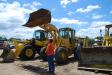 A customer takes measurements on this 1991 Caterpillar 916 wheel loader.