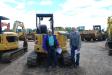 Ronnie (L) and Donnie Foley from Robertsdale, Ala., show interest in this 2014 Caterpillar 305ECR mini-excavator.
