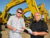 Vance Terry (L) and Bryan Boyd, both of Gunter Construction, Lawrenceville, Ga., check  out the excavators.  