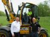 JCB Hydradig General Manager Ken Covell (L) and Large Excavator Product Specialist Tyler Peterson (R) encouraged Daniel Tautin of West Mead Township to try the new JCB Hydradig out for himself.