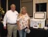 Gene Taylor (L), owner of Warrior Tractor, presents one of the prize drawings, a Calcutta cooler, to Danna Martin of David Martin Logging, Nauvoo, Ala.