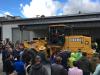 The crowd sees one of four John Deere 624H wheel loaders sold at the auction.
