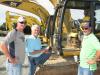 (L-R): Scott Kelly, Strack Inc., Fairburn, Ga., and Tony Kelly and Alan Pratt, both of MA-JAC Underground, Sharpsburg, Ga., talk about some of the machines at  the auction.