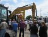 Auction attendees gather to bid on a strong selection of excavators at the sale.