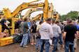 The crowd swarmed in to bid on the excavators. This Komatsu sold for $190,000.