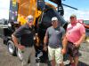 (L-R): Kurt Schwartz of KM International speaks with Shane Slaven and Troy Landers of Delaware County about his company’s KM T2 asphalt recycler.