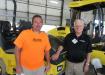Joe Jones (L) of Elite Asphalt speaks with Dale Alferink, Bomag territory manager, about adding another Bomag to his fleet.