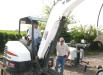 Lane (L) and Kenneth Anders, both of Anders Farms, Hartselle, Ala., try out a Bobcat E42 mini-excavator.
