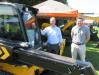 Jim Blower (L), JCB factory representative, joins Kevin Ray of Burns JCB to introduce the new JCB teleskid, a hybrid machine with telescopic boom, functioning as both a skid steer and telehandler.
