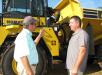 Joey Martin (L), owner of Joey Martin Auctioneers, talks with his friend Mark Doty, W.I. Clark Company, Wallingford, Conn.  
