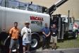(L-R): Jared Wilson, environmental specialist, John Rosebery, sales manager, and Ismael Dominguez, territory product support, all of Great Southern Equipment Company, talk with Tod Ebetino, regional sales manager, Gradall Industries, in front of a Vacall machine.