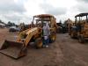 Dennis Kendrick from Wiggins, Miss., stands with a 2002 John Deere 110 4x4 loader backhoe that was sold in Brooklyn, Miss.