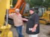Mike Moody (L) of Mountaineer Construction, Maggie Valley, N.C., talks with Sam Ingram, Martin & Martin, about some of the excavators.