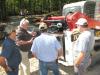 Takeuchi’s Dennis Parker (C) goes over the power plant and the overall serviceability of the Takeuchi TL12V2 compact track loader.