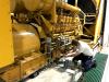 Jeremy Foster, Carolina Cat power generation technician, repairs a diesel fuel issue on a generator.
