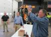 (R-L): Nick Harlan of Evansville parts department, takes a shot at the basket for a door prize as Adam Doll and Don Miller, both of Case Construction Equipment, supervise.
