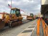 Caterpillar crawler loaders rumble over the auction ramp.