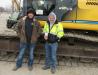 Josh (L) and Dick Myers, both of R.A. Myers Construction, gave a Kobelco SK350 excavator the once over before considering a bid. 
