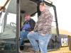 Justin Smith (L) and Derek Farmer, both of Smith Auto Salvage, Chapmansboro, Tenn., check out  a Cat 924G.