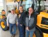 (L-R): Buck & Knobby JCB’s Jeff Wente provided father and son team Tyson and Phil Aeschliman of Aeschliman Cattle LLC information about the JCB wheel loader.
