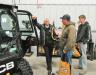 (L-R): Buck & Knobby JCB’s Gerry Maibach discusses features of this JCB 190 Eco skid steer loader with John and David Russell, both of JD Russell Hay & Straw.

