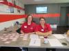 Kari Schmidt (L) and Sara Facenba, both of Deutz Service Center in Chicago, register customers and give a gift bag to all open house guests. 