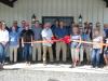 A great turnout of vendors and local dignitaries arrived to join owners Tim and Kimberly Moore and sales and service manager Kenny Wallace (C) for the official ribbon-cutting on June 7.