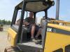 Jason Kriegmont of Jason’s Service tries out a Caterpillar D3K crawler tractor at the auction.
