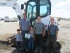 Noah Cross of Crosscut Tree Service along with his sons (L-R) Travis, Roger, Malvern and Marcus were pleased to have placed the winning bid on this Bobcat E80 compact excavator. 
