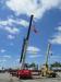 A Link-Belt crane hoists a Ritchie Bros. flag and an American flag at the auction.
