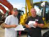 Jeremey Nichols (L) and Nevin Tidmore, both of West Alabama Mechanical Inc. in Moundville, Ala., check their notes on a few excavators of interest.