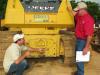 Clay Allen (L) and Jimmy Allen, both of High Pine Farms in Roanoke, Ala., inspect a Deere 750K dozer. 